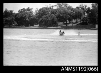 Black and white negative number 21 depicting open power boat with outboard engine