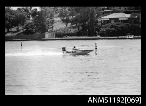 Black and white negative number 26A depicting image open power boat NIPPER QUICK ii Kf88n with outboard engine