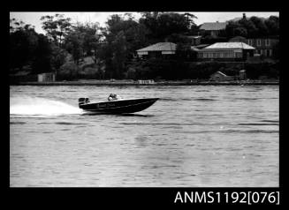 Black and white negative number 34 depicting image open power boat NAUTI LASS , Kt1twon outboard engine