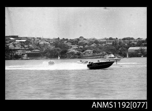 Black and white negative number 34A depicting image open power boat NAUTI LASS , Kt1twon outboard engine