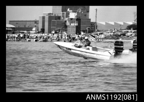 Black and white negative number 5 depicting image open power boat GOLD POWER , EO69N outboard engine at speed