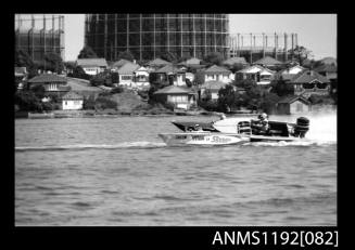 Black and white negative number 6 depicting image open power boat Viva , J193n outboard engine at speed