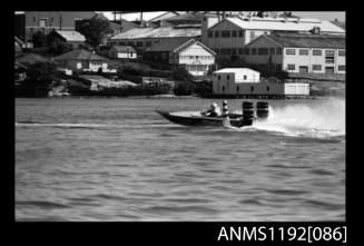 Black and white negative number 10 depicting open power boat STAR , outboard engine passing a marker buoy