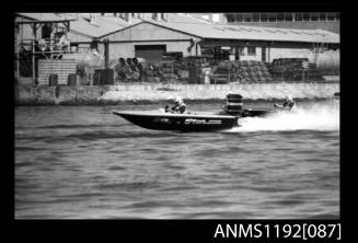 Black and white negative number 11 depicting open power boat STAR Jo4on outboard engine at speed