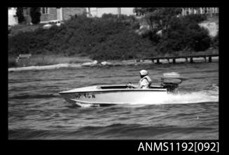 Black and white negative number 16 depicting open power boat Hp46n outboard engines at speed