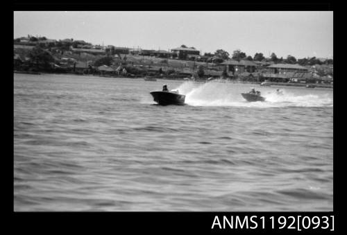 Black and white negative number 17 depicting two open power boats at speed