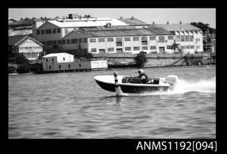 Black and white negative number 18 depicting open power boat IN-THE-RED Passing marker buoy