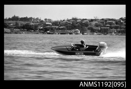 Black and white negative number 19 depicting open power boat HUNTER At speed