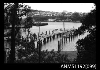 Black and white negative number 2 depicting a long jetty and mooring posts at Cabarita Power Boat Races, Parramatta River, Sydney, New South Wales