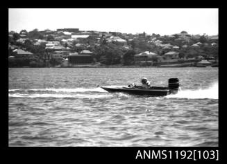 Black and white negative number 4A depicting racing power boat with outboard engine at high speed