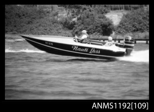 Black and white negative number 10A depicting NAUTI LASS , Kt1twon Racing power boat with outboard engine at speed