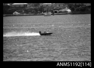 Black and white negative number 15A depicting racing power boat with outboard engine at speed