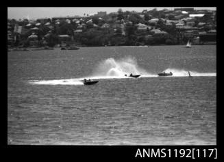 Black and white negative number 18A depicting 3 racing power boats with outboard engines at turning marker