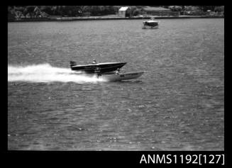 Black and white negative number 28A depicting power boats NAUTI-LASS And Ace At speed, neck to neck