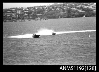 Black and white negative number 29A depicting two power boats turning at high speed