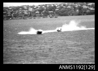 Black and white negative number 30A depicting two power boats turning at high speed