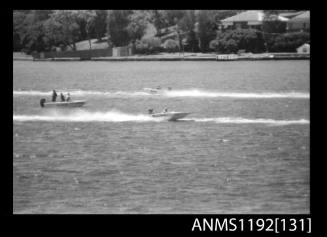 Black and white negative number 32A depicting NIPPER WASP And another power boat travelling in the opposite direction, passing a stationary power boat