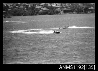 Two power boats racing around a turning marker