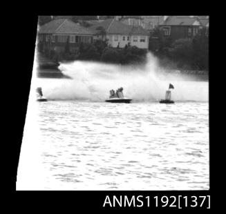 Black and white negative number 1 depicting power boat completing turn at marker buoy