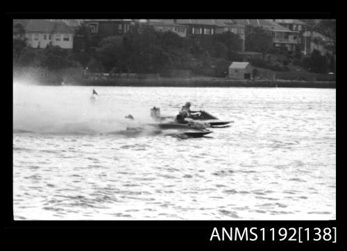 Black and white negative number 2 depicting two power boats, neck to neck