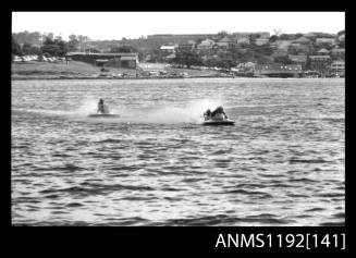 Black and white negative number 5 depicting two power boats at speed