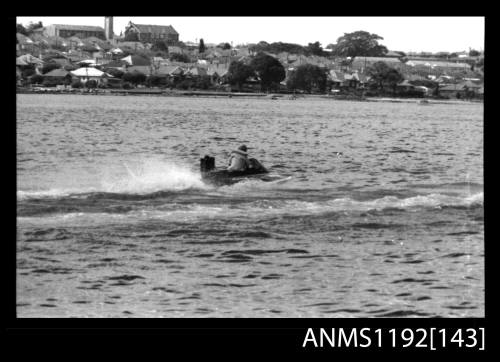 Black and white negative number 7 depicting power boat under way