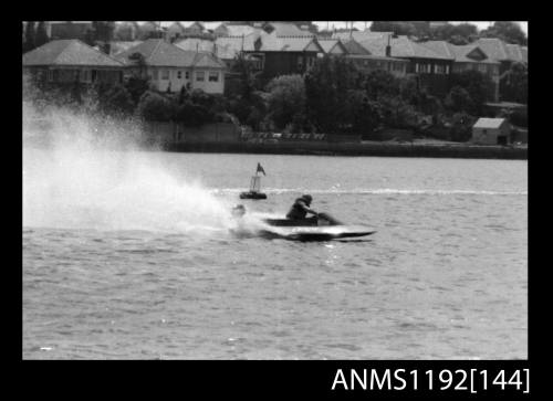 Black and white negative number 8 depicting power boat Gy8twon At speed passing marker buoy