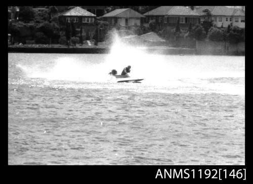 Black and white negative number 10 depicting power boat at speed completing a turn