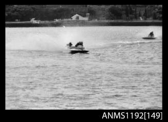 Power boat at speed at outboard engined hydroplane titles, Cabarita, Parramatta River, Sydney