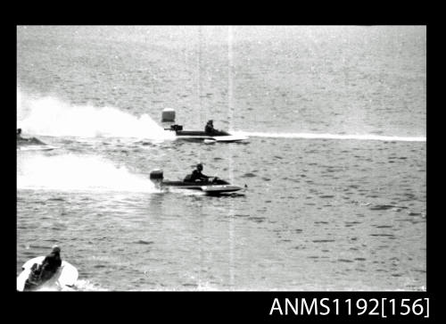 Black and white negative number 20 depicting two power boats at speed, neck to neck