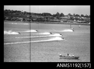 Black and white negative number 21 depicting 6 power boats at speed