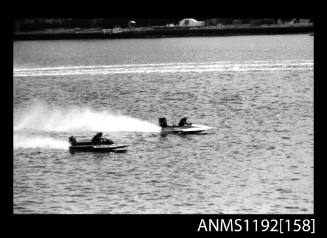 Black and white negative number 22 depicting two power boats at speed, including 919N