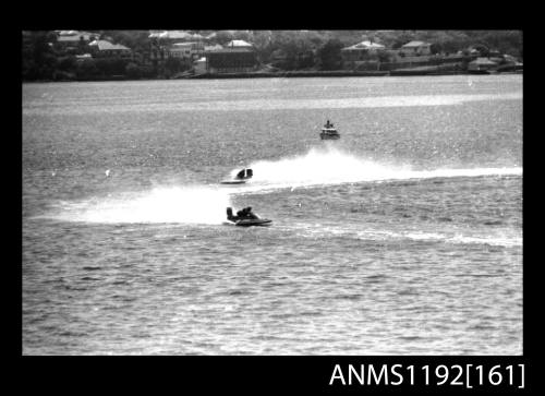 Black and white negative number 25 depicting two power boats at speed, turning at marker buoy