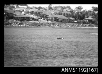 Black and white negative number 31 depicting power boat stationary midstream