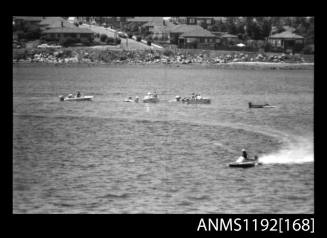 Black and white negative number 32 depicting power boat completing a turn