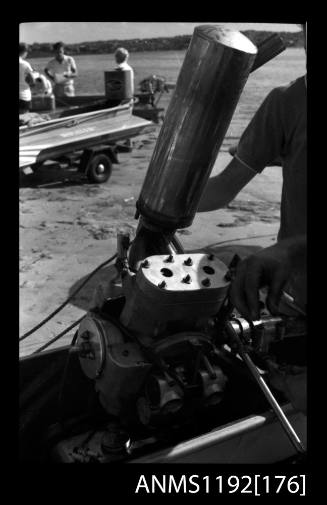 Black and white negative number 9 depicting outboard engine with large exhaust pipe in foreground