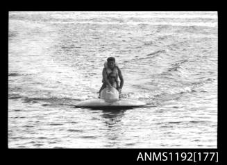 Black and white negative number 10 depicting power boat underway, bow-on view at outboard engined hydroplane titles, Cabarita, Parramatta River, Sydney