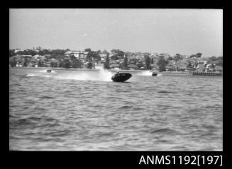 Black and white negative number 9A depicting power boat at speed  Bow/ starboard side view at Stuart Doyle Gold Cup in New South Wales