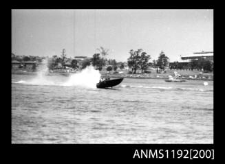 Black and white negative number 12A depicting power boat at speed  Bow/ starboard side view at Stuart Doyle Gold Cup in New South Wales