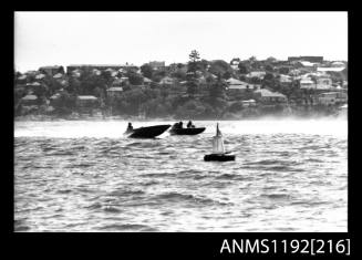 Black and white negative number 7A depicting two power boats passing marker buoy