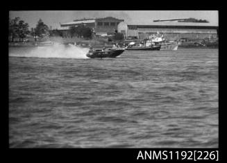 Black and white negative number 18 depicting power boat at speed  Bow/ starboard side view at Stuart Doyle Gold Cup in New South Wales