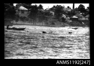 Black and white negative number 19 depicting sunken power boat and approaching rescue boat at Stuart Doyle Gold Cup in New South Wales