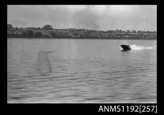 Black and white negative number 16 depicting view MELODEE III AA4N open power boat at speed