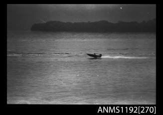 Black and white negative number 13A depicting view of open power boat at speed