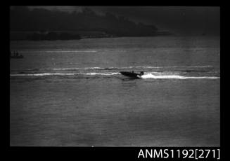 Black and white negative number 14A depicting view of open power boat at speed