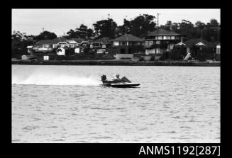 Black and white negative number 15A depicting power boat at speed  starboard side view at time trials at St George Motor Boat Club, Georges River, Sans Souci, Sydney, New South Wales