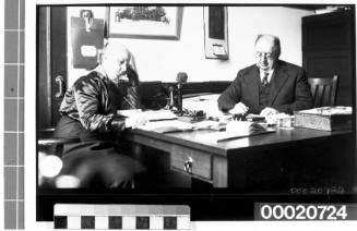 An unidentified man and woman seated at a table