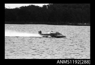 Black and white negative number 16A depicting power boat at speed  starboard side view at time trials at St George Motor Boat Club, Georges River, Sans Souci, Sydney, New South Wales