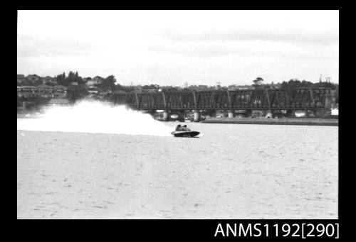 Black and white negative number 18A depicting power boat at speed  Bow/ starboard side view at time trials at St George Motor Boat Club, Georges River, Sans Souci, Sydney, New South Wales