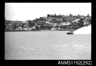 Black and white negative number 20A depicting power boat at speed  Bow/ port side view at time trials at St George Motor Boat Club, Georges River, Sans Souci, Sydney, New South Wales